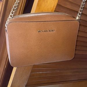 Michael Kors cross body bag. Has a tear on the strap which is pictured.
